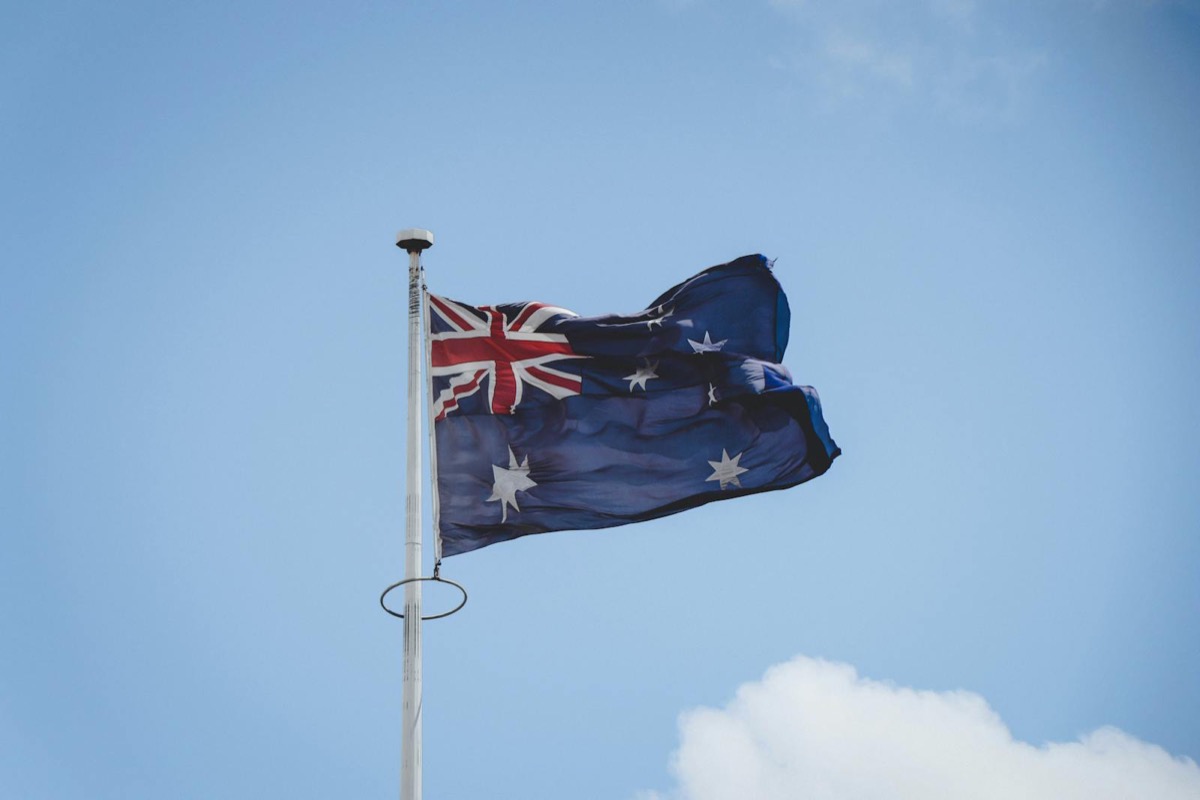 The Australian national flag against a blue sky