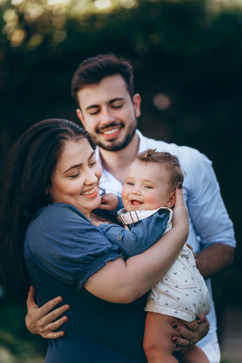 New parents holding their baby